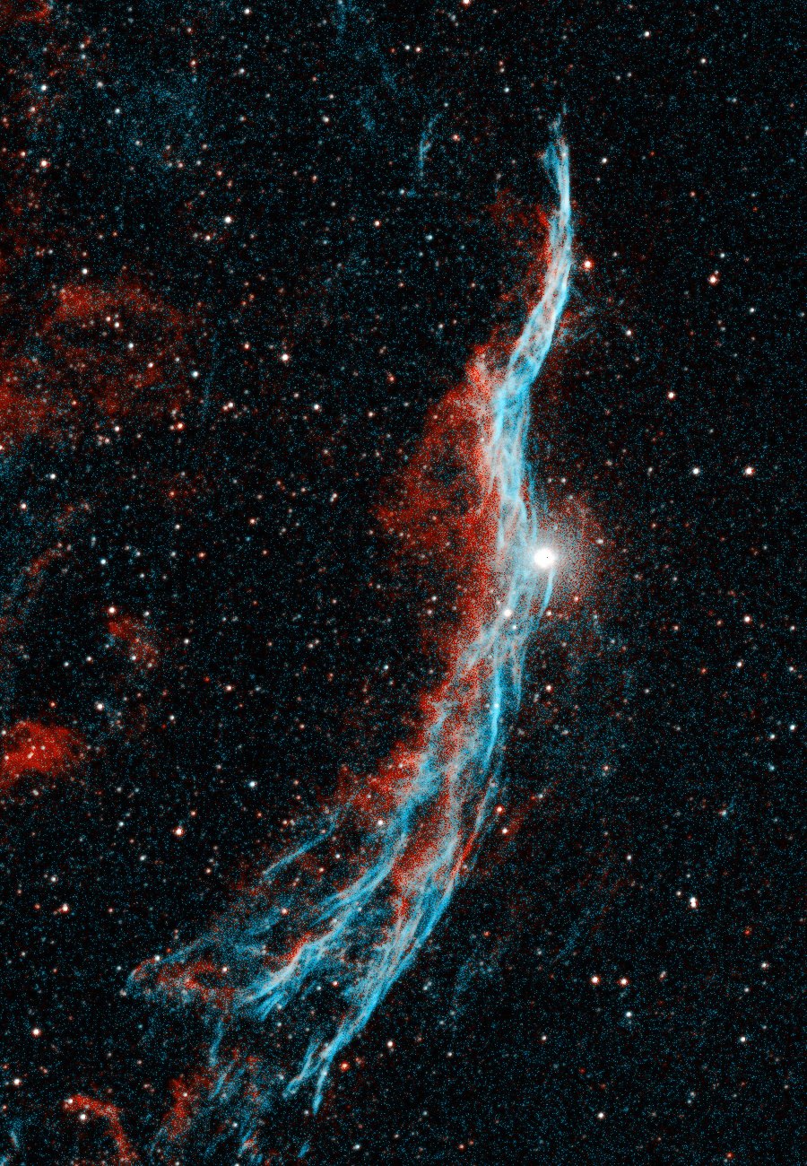 A close-up of a long curved filament running top to bottom, braided strands of bright blue along its leading edge with red glowing behind, sweeping past a bright white star near the middle.